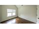 Bright bedroom with hardwood floors, a large window, and neutral walls for a relaxing space at 8744 Hamil Ct, Douglasville, GA 30135