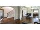 A beautiful home foyer features hardwood floors, wainscoting, arches, and staircase with iron spindles at 8744 Hamil Ct, Douglasville, GA 30135