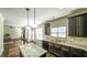 Kitchen features hardwood floors, granite countertops, dark cabinets and stainless steel appliances at 8744 Hamil Ct, Douglasville, GA 30135