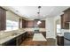 Kitchen with hardwood floors, granite counters, stainless appliances and dark cabinets at 8744 Hamil Ct, Douglasville, GA 30135