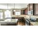 Spacious kitchen with stainless steel appliances, island, granite countertops and hardwood floors at 8744 Hamil Ct, Douglasville, GA 30135