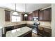 Kitchen features dark wood cabinets, granite counters, stainless steel appliances and hardwood flooring at 8744 Hamil Ct, Douglasville, GA 30135