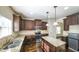 Kitchen with hardwood floors, granite counters, stainless appliances and dark cabinets at 8744 Hamil Ct, Douglasville, GA 30135