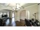 An elegant living space featuring hardwood floors, wainscoting, arched entryways, and an open floor plan at 8744 Hamil Ct, Douglasville, GA 30135