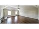 Living room boasts hardwood floors, fan, high vaulted ceiling, and large windows at 8744 Hamil Ct, Douglasville, GA 30135