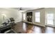 Spacious living room with hardwood floors, a stone fireplace, ceiling fan, and lots of light at 8744 Hamil Ct, Douglasville, GA 30135