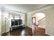 Bright living room with hardwood floors, bay window, and arched doorway at 8744 Hamil Ct, Douglasville, GA 30135