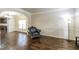 Living room featuring hardwood floors, wainscoting, and view of kitchen and dining area at 8744 Hamil Ct, Douglasville, GA 30135