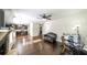Open-concept living room with hardwood floors, stone fireplace, and ceiling fan at 8744 Hamil Ct, Douglasville, GA 30135