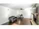 This living room features a ceiling fan, stone fireplace, and hardwood floors at 8744 Hamil Ct, Douglasville, GA 30135