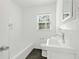 Bright bathroom featuring tiled walls, tub and shower combination, and a modern sink with stylish fixtures at 1844 Stanton St, Decatur, GA 30032