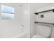 A stylish bathroom featuring white subway tile, a bathtub, and modern shelving accents at 1844 Stanton St, Decatur, GA 30032
