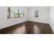 Bedroom featuring hardwood floors, white walls, and two large windows at 1844 Stanton St, Decatur, GA 30032