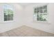 Bedroom with two windows, neutral tile floor, and white trim at 1844 Stanton St, Decatur, GA 30032