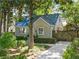 Charming home featuring a metal roof, painted brick exterior, lush landscaping, and private driveway at 1844 Stanton St, Decatur, GA 30032