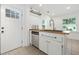Kitchen with stainless steel dishwasher, butcher block countertop and white cabinets at 1844 Stanton St, Decatur, GA 30032