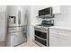 Stainless steel appliances, white cabinets and mosaic tile backsplash in bright kitchen at 1844 Stanton St, Decatur, GA 30032