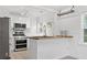 Bright kitchen featuring stainless steel appliances, butcher block countertop, and white cabinets at 1844 Stanton St, Decatur, GA 30032