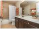 Well-lit bathroom features a vanity with dark cabinetry, large mirror, and shower-tub combo at 2025 Eagle Rdg, Roswell, GA 30076