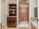 Bathroom featuring tiled shower, bathtub, vanity, and linen storage at 2025 Eagle Rdg, Roswell, GA 30076