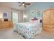 Colorful bedroom with natural light, decorative furniture, and ceiling fan at 2025 Eagle Rdg, Roswell, GA 30076