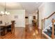Formal dining room with hardwood floors and decorative wainscoting adjacent to an open floorplan at 2025 Eagle Rdg, Roswell, GA 30076