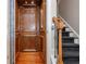 Interior elevator with wood-paneled walls and hardwood floors, located by the staircase at 2025 Eagle Rdg, Roswell, GA 30076