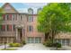 Charming brick townhome with manicured landscaping, attached garage, and inviting curb appeal at 2025 Eagle Rdg, Roswell, GA 30076