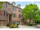 Beautiful brick townhomes featuring attached garages and manicured front yard landscaping at 2025 Eagle Rdg, Roswell, GA 30076