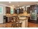 Modern kitchen with dark wood cabinets, mosaic backsplash, and stainless steel appliances at 2025 Eagle Rdg, Roswell, GA 30076