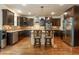 Well-appointed kitchen featuring stainless steel appliances, island, and custom dark wood cabinetry at 2025 Eagle Rdg, Roswell, GA 30076