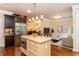 Bright kitchen featuring stainless steel appliances, an island, and hardwood floors at 2025 Eagle Rdg, Roswell, GA 30076