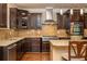 Elegant kitchen features a stainless steel range hood, mosaic backsplash, and custom cabinetry at 2025 Eagle Rdg, Roswell, GA 30076