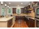 Bright kitchen with a center island, stainless steel appliances, and dark wood cabinetry at 2025 Eagle Rdg, Roswell, GA 30076