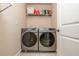 A conveniently located laundry room features a modern washer and dryer plus shelf storage at 2025 Eagle Rdg, Roswell, GA 30076