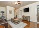 Cozy living room features hardwood floors, a ceiling fan and an entertainment center at 2025 Eagle Rdg, Roswell, GA 30076