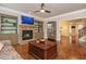 Stylish living room featuring a stone fireplace, built-in shelves, and hardwood floors at 2025 Eagle Rdg, Roswell, GA 30076