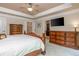 Bright main bedroom featuring a wall-mounted television and custom dresser at 2025 Eagle Rdg, Roswell, GA 30076