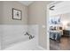 Modern bathtub features a marble backsplash, with doorway view of bedroom at 3386 Vintage Se Cir # 8, Smyrna, GA 30080