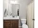 Cozy bathroom features a vanity with a white countertop and wood cabinets, along with a toilet and shower at 3386 Vintage Se Cir # 8, Smyrna, GA 30080