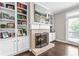 Close up of a living room fireplace with built-in bookshelves and hardwood floors at 3386 Vintage Se Cir # 8, Smyrna, GA 30080