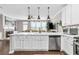 Bright, white kitchen featuring stainless steel appliances, a large island, and seamless connectivity to the living area at 3386 Vintage Se Cir # 8, Smyrna, GA 30080