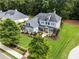 Stunning aerial view of a home with manicured lawns and mature trees at 4115 Williams Point Dr, Cumming, GA 30028