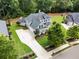Stunning aerial view of a two-story home with a gray roof, long driveway, and lush green lawn at 4115 Williams Point Dr, Cumming, GA 30028