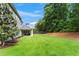 Expansive backyard with well-manicured lawn and view of the home's exterior at 4115 Williams Point Dr, Cumming, GA 30028