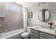 Well-lit bathroom with a tub and shower combo, granite countertop, and modern fixtures at 4115 Williams Point Dr, Cumming, GA 30028
