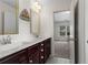 Bright bathroom with double sink vanity, modern fixtures, and an open doorway at 4115 Williams Point Dr, Cumming, GA 30028