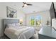 Comfortable bedroom with a ceiling fan, window views, and stylish décor for peaceful relaxation at 4115 Williams Point Dr, Cumming, GA 30028