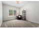 Carpeted bedroom with a large window and a cozy reading nook at 4115 Williams Point Dr, Cumming, GA 30028