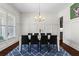 Elegant dining room with modern lighting and seating for eight, perfect for hosting gatherings at 4115 Williams Point Dr, Cumming, GA 30028